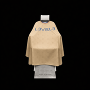 Beige hairdressing cape with 'L3VEL3' branding on a black background