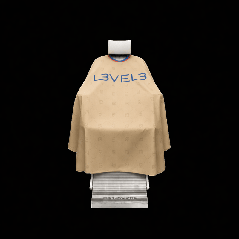 Beige hairdressing cape with 'L3VEL3' branding on a black background