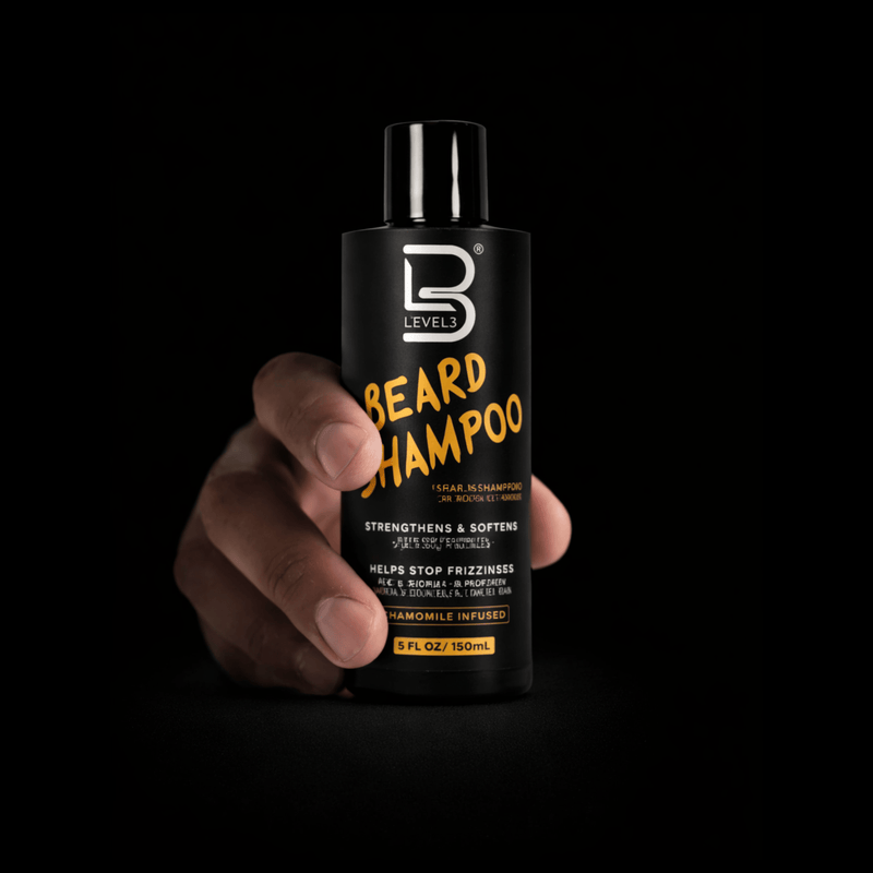Level 3 beard shampoo bottle held in a hand against a black background