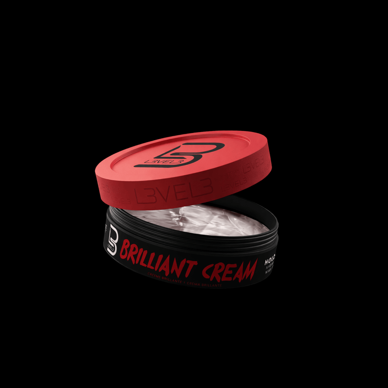 Open container of 'Brilliant white Cream' with red lid on a black background