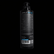 Black bottle of L'VEL3 hair tonic on a black background