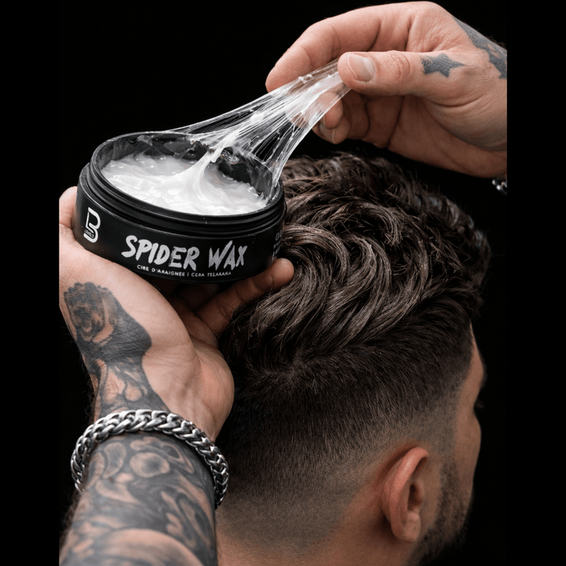 Person applying sticky spider wax to hair with a black container.