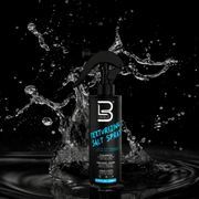 Texturizing salt spray bottle with water splash on a black background