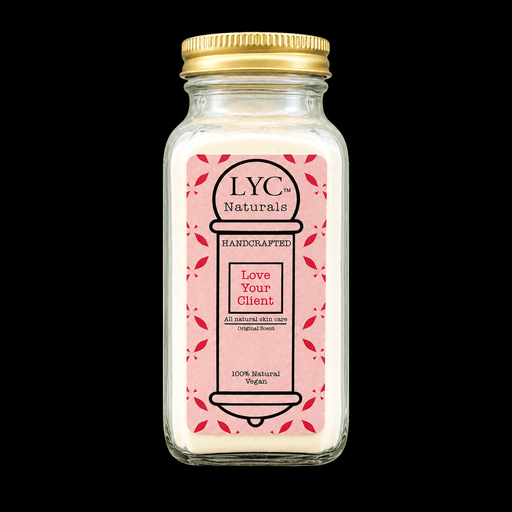 LYC Naturals Skin Care Powder in Original Coconut scent, glass jar with gold lid and pink Love Your Client label, on a black background