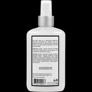 White spray bottle with a label on a black background