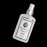 Bottle of Mane Tame after shave balm on a black background