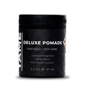 Black container of Deluxe Pomade with white text on a white background