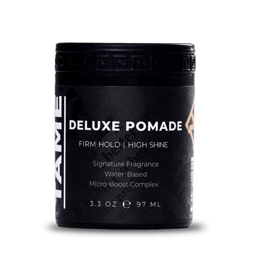 Black container of Deluxe Pomade with white text on a white background