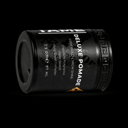 Black container of Deluxe Pomade with text on a black background