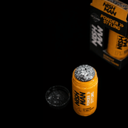 Orange bottle with white powder showing  on top of container with 'Nish Man' label amd package on a black background