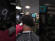 Barber using Cocco Veloce Pro Trimmer for lineup and detailing in barbershop