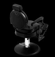 Primos Studio Barber Chair - rear view showing smooth oval backrest and ornate filigree footrest in all-black finish
