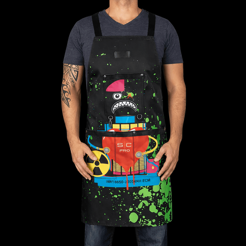 Person wearing a colorful apron with a cartoon character design on a black background