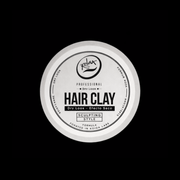 Koida Labs hair clay container on a black background