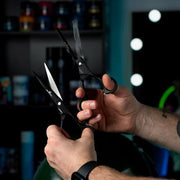 Professional barber using Rolda Black 7 Inch Shear Set for precision hair cutting and blending