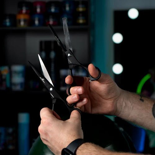 Professional barber using Rolda Black 7 Inch Shear Set for precision hair cutting and blending