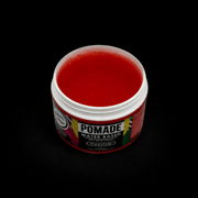 Red water-based pomade jar showing the red jelly like pomade with a blackground 