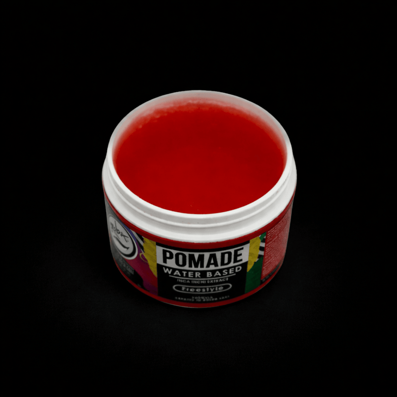 Red water-based pomade jar showing the red jelly like pomade with a blackground 