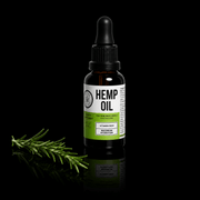 Bottle of hemp oil with a dropper on a black background