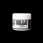 Front view of jar of hair clay on a black background