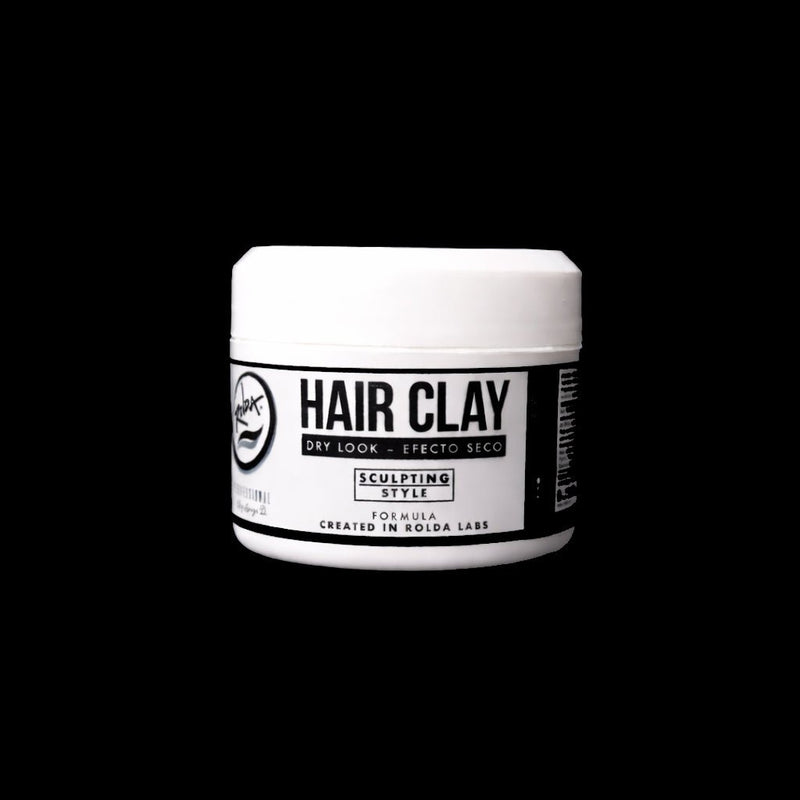 Front view of jar of hair clay on a black background