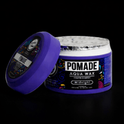 Purple jar of pomade with open lid slanted on the side, with a black background. Primos Barber Supply