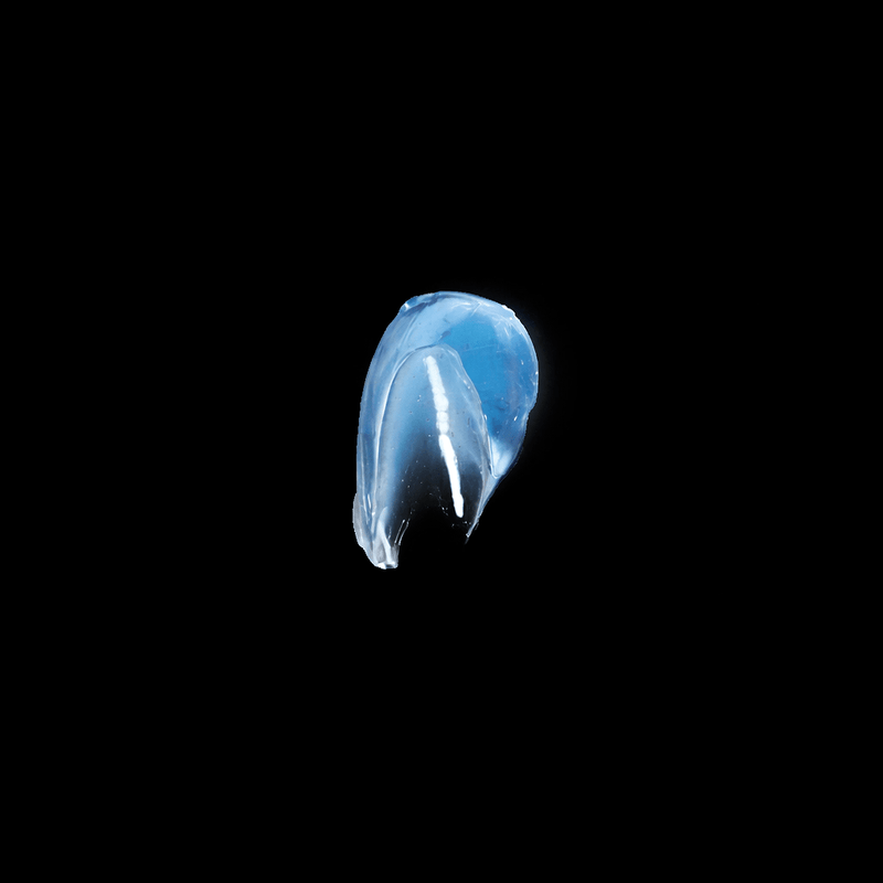 Blue jelly-like substance smear on a black background-Primos-Barber-Supply