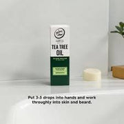 Rolda Tea Tree Beard Oil box on a bathroom sink with directions: put 3-5 drops into hands and work through skin and beard