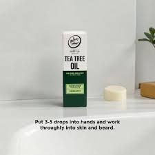 Rolda Tea Tree Beard Oil box on a bathroom sink with directions: put 3-5 drops into hands and work through skin and beard