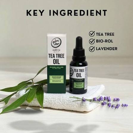 Rolda Tea Tree Beard Oil 30ml box and dropper bottle on a towel with key ingredients tea tree, Bio-Rol, and lavender
