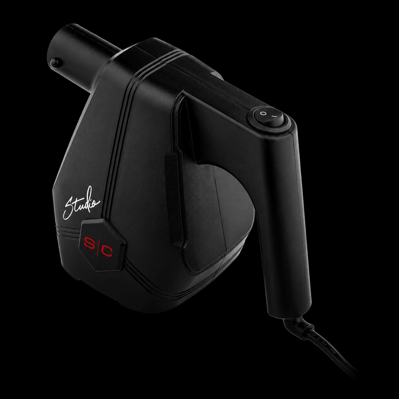 Black hair dryer with 'Studio' branding on a black background