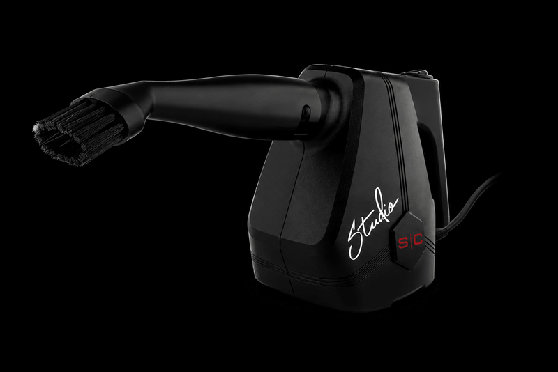 Black hair dryer with 'Studio' branding on a black background
