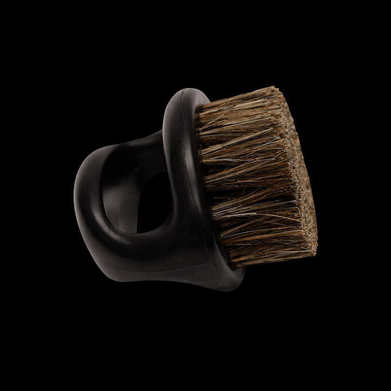 Boar bristle brush side view on a black background.