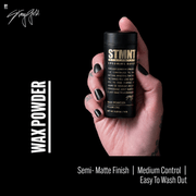 Hand holding STMNT Wax Powder hair styling powder with semi matte finish and medium control
