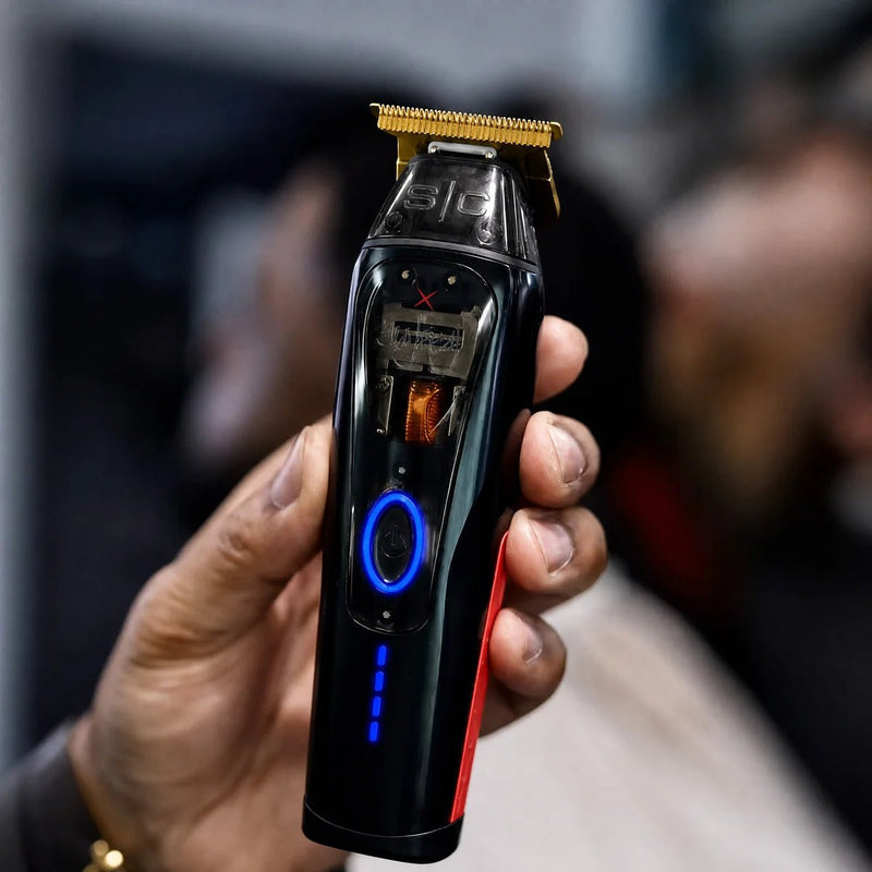 StyleCraft x 360 Jeezy Cordless Trimmer SC423B - barber holding the trimmer in the shop