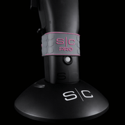 Low angle of black trimmer with 'SC' branding grip on a black background