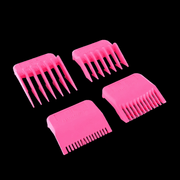 Four pink hair comb attachments on a black background