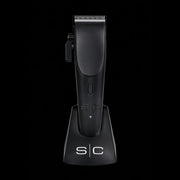 StyleCraft Ergo clipper placed vertically in its professional anti-slip charging dock for workstation organization.