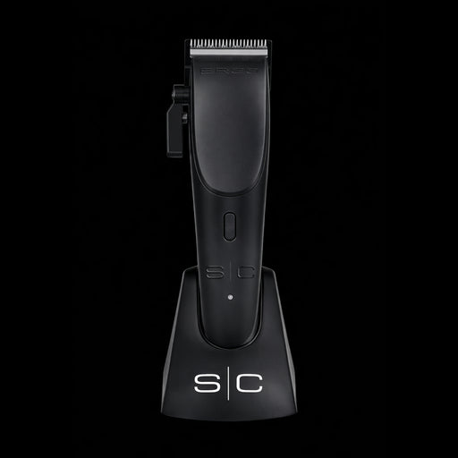StyleCraft Ergo clipper placed vertically in its professional anti-slip charging dock for workstation organization.