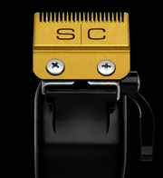 Gold clipper blade with 'SC' branding on a black background