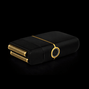 Black and gold electronic device with a reflective surface on a black background