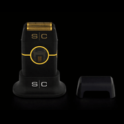 Black and gold electric shaver with 's/c' branding on a black background