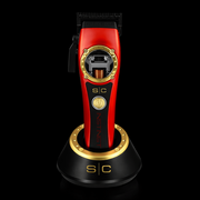 Red and gold hair trimmer on a black background
