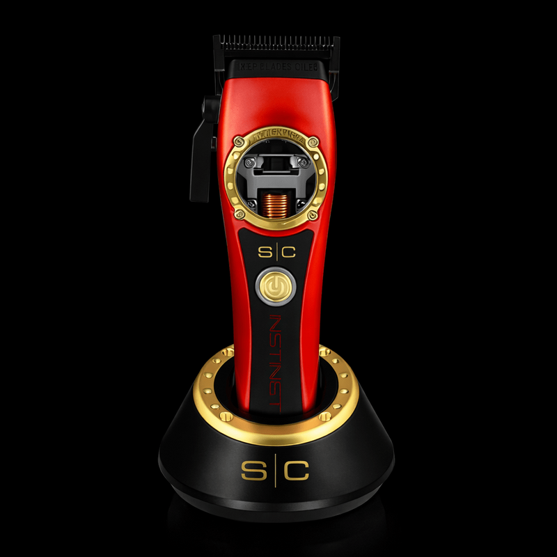 Red and gold hair trimmer on a black background
