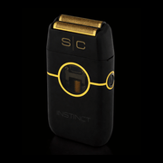 Black and gold electric shaver with 'SC' branding on a black background