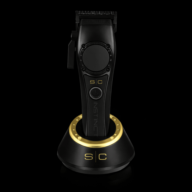 Black and gold hair trimmer on a black background