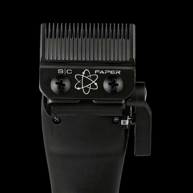 Black hair clipper with comb attachment on a black background