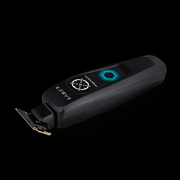 Black grooming clipper with brand logo on a black background