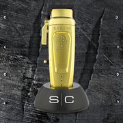 Gold lighter with 'Saber II' branding on a textured black background