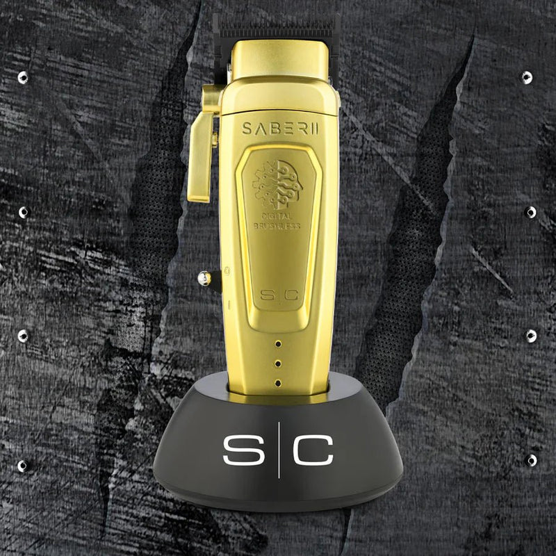 Gold lighter with 'Saber II' branding on a textured black background